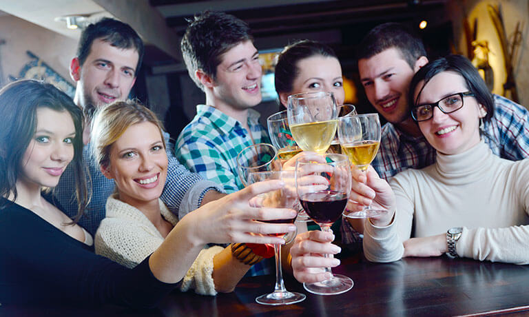 a group of people holding wine glasses