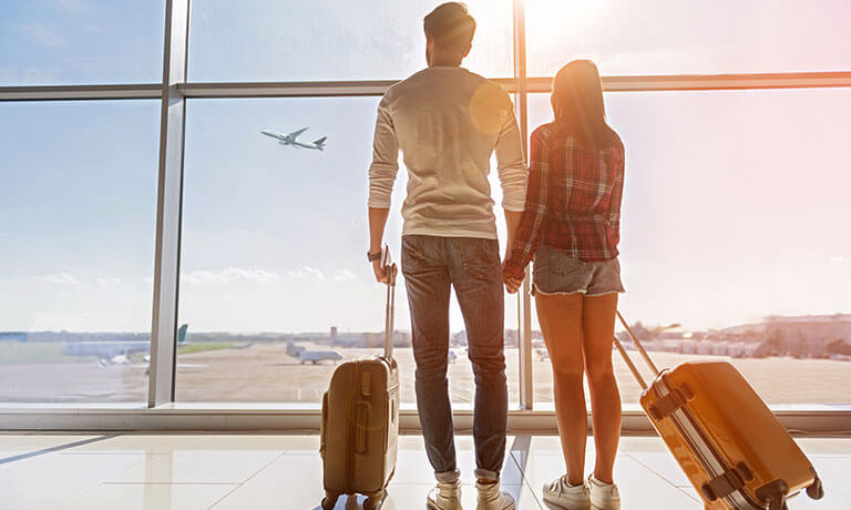 a man and woman with luggage