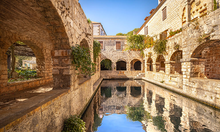 a stone bridge over a river