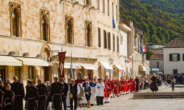 a group of people standing in a street