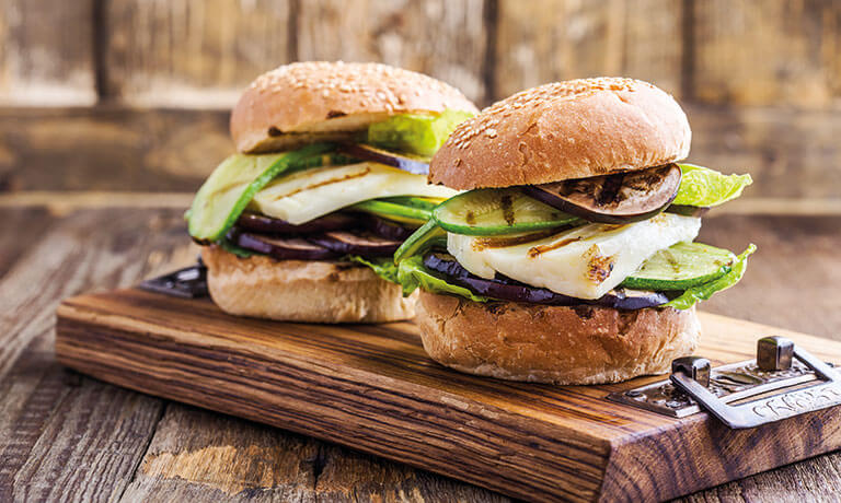 a group of sandwiches on a cutting board