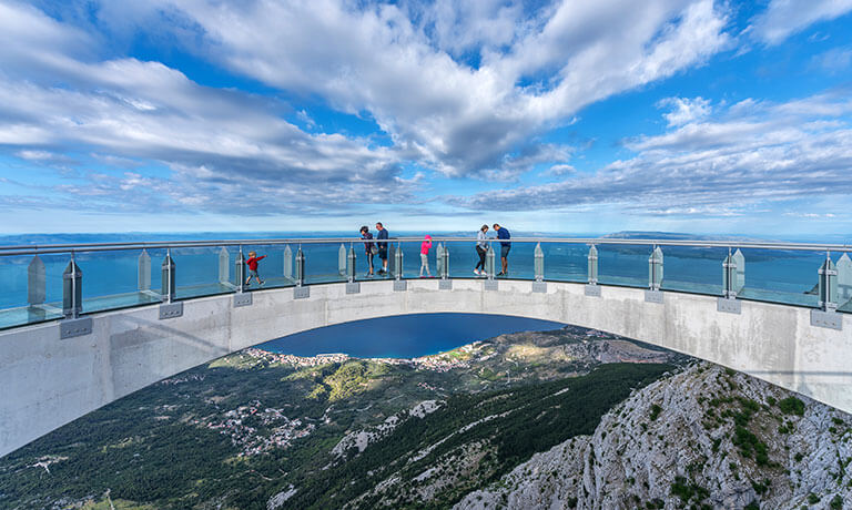 a group of people walking on a bridge