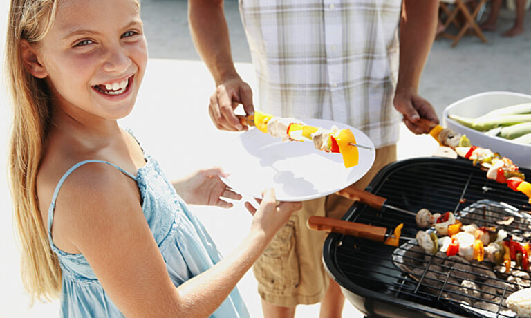 a girl holding a plate of food