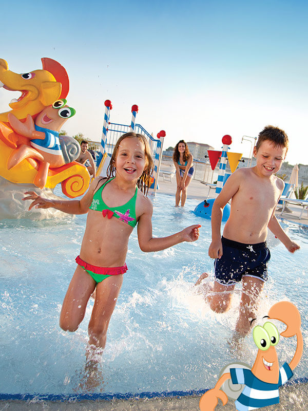 a boy and girl in a pool