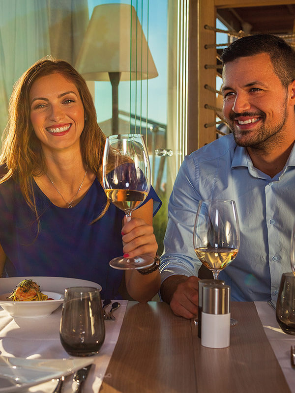 a man and a woman holding wine glasses