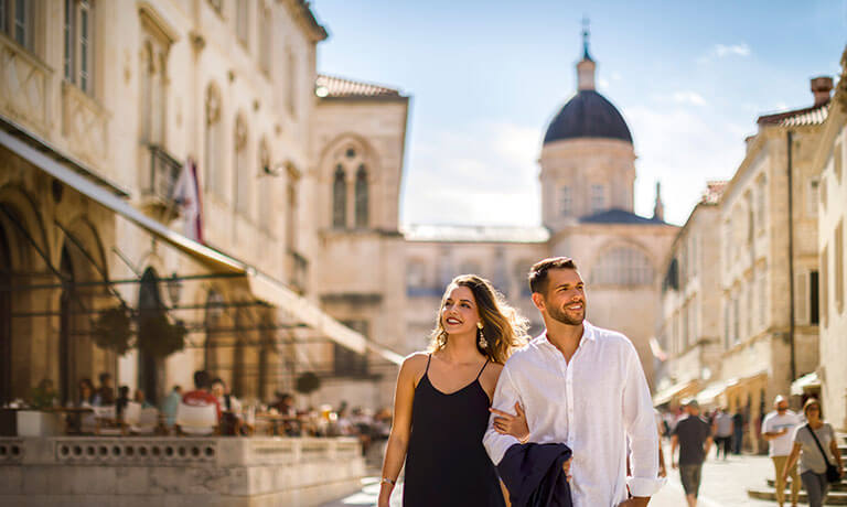 a man and woman posing for a picture in a city