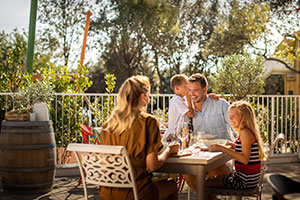 a group of people sitting at a table outside