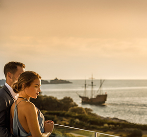 a man and woman looking at a boat in the water