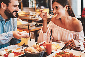 a man and a woman eating at a restaurant