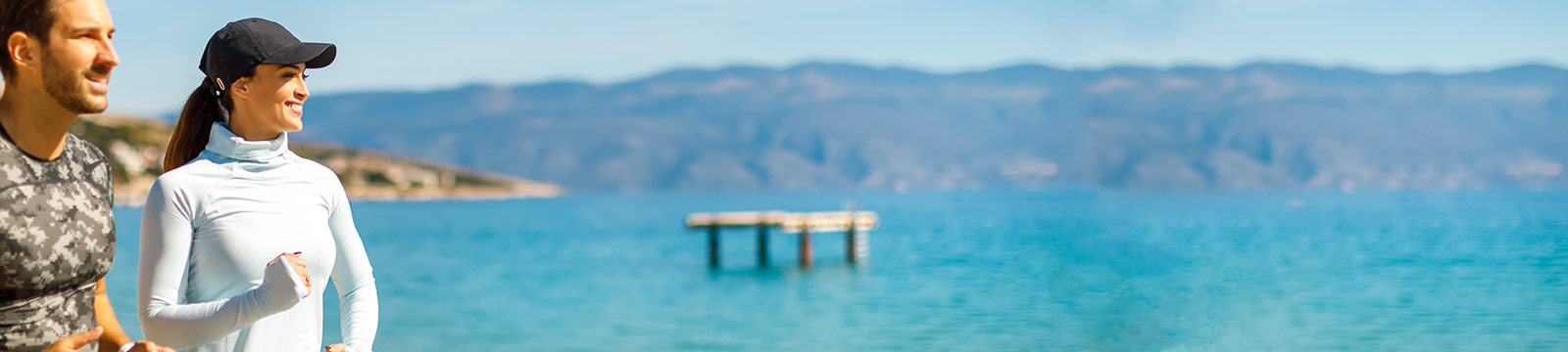 a man and woman standing next to a body of water